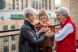 three senior woman on rooftop patio