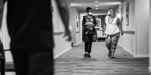 Two female Ecumen employees walking down hall
