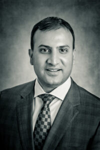 Professional black & white headshot of Dr. Cyrus Batheja, EdD, MBA, RN, FAAN