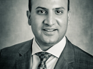 Professional black & white headshot of Dr. Cyrus Batheja, EdD, MBA, RN, FAAN
