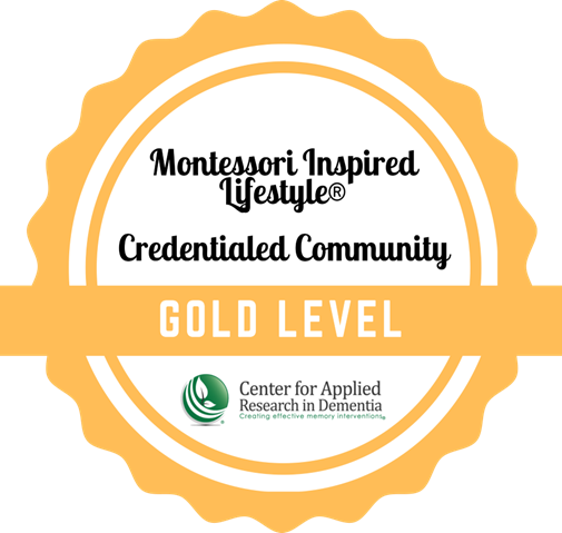 Montessori Inspired Lifestyle trademark Credentialed Community Award badge graphic labeled gold level, issued by Center for Applied Research in Dementia
