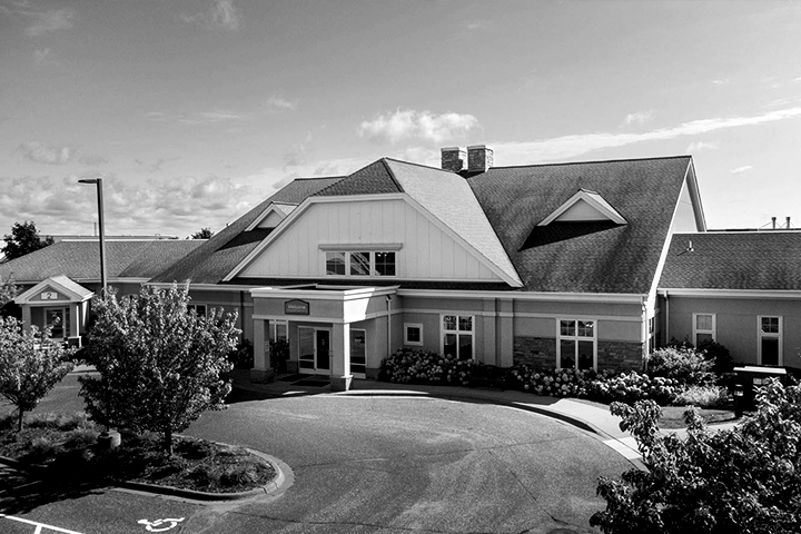 Black and white exterior photo of a Ecumen North Branch's main entrance.
