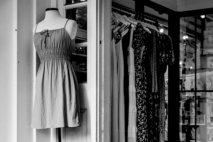 Black and white photo of a shop merchandising display for women's summer wear.