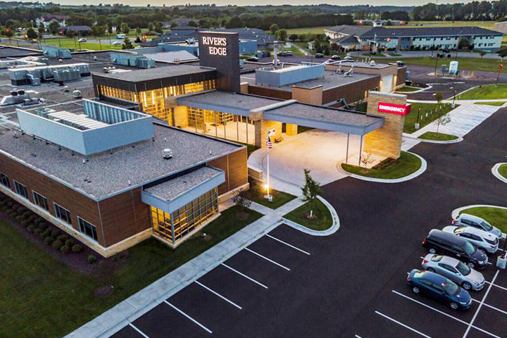 Aerial view of Rivers Edge main entrance with carport and parking lot.