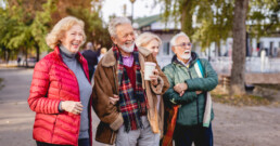 Four smiling seniors outdoors in the Fall