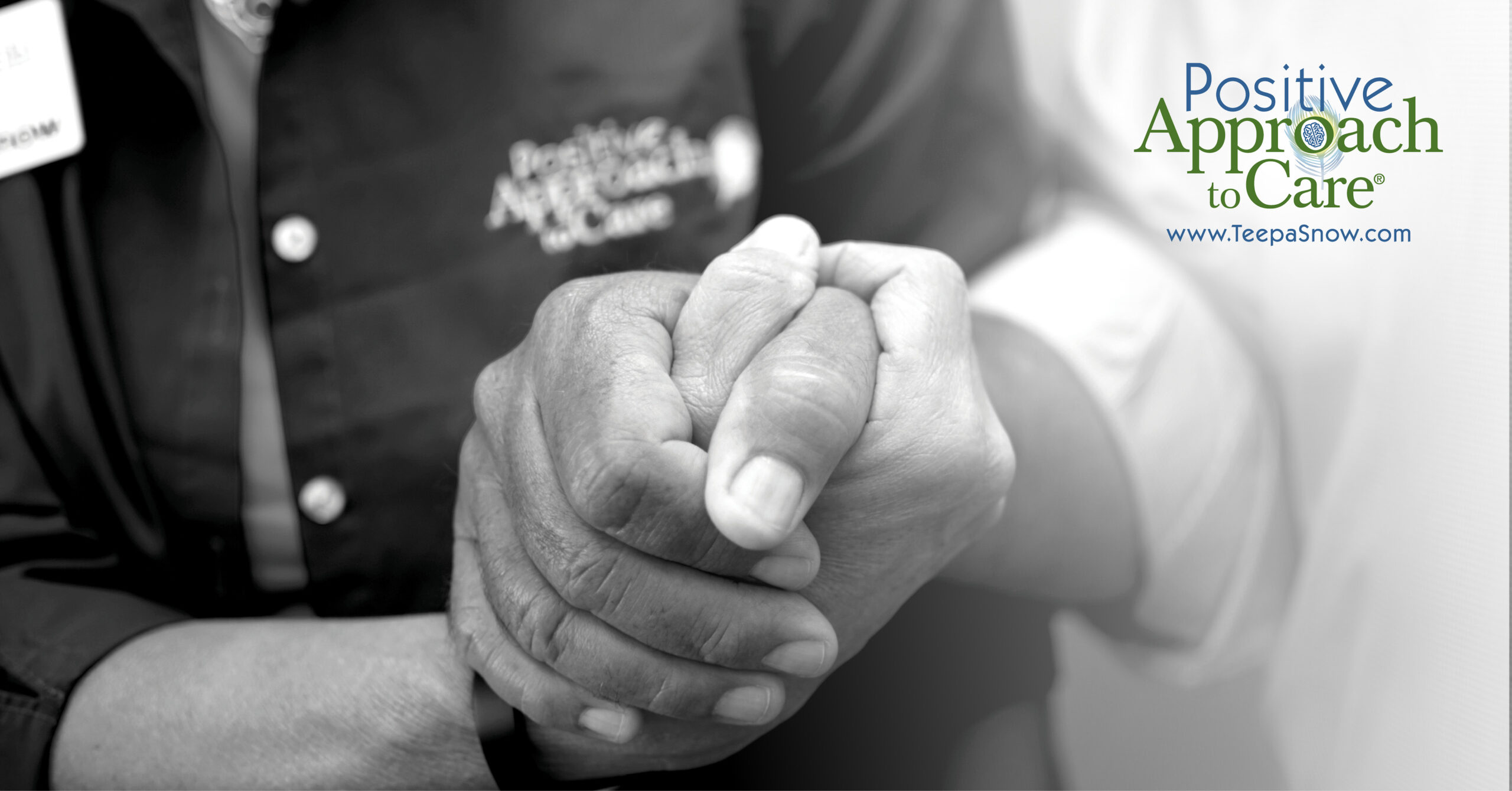 A black and white close-up of two people holding hands, with text announcing Teepa Snow’s Positive Approach to Dementia Care