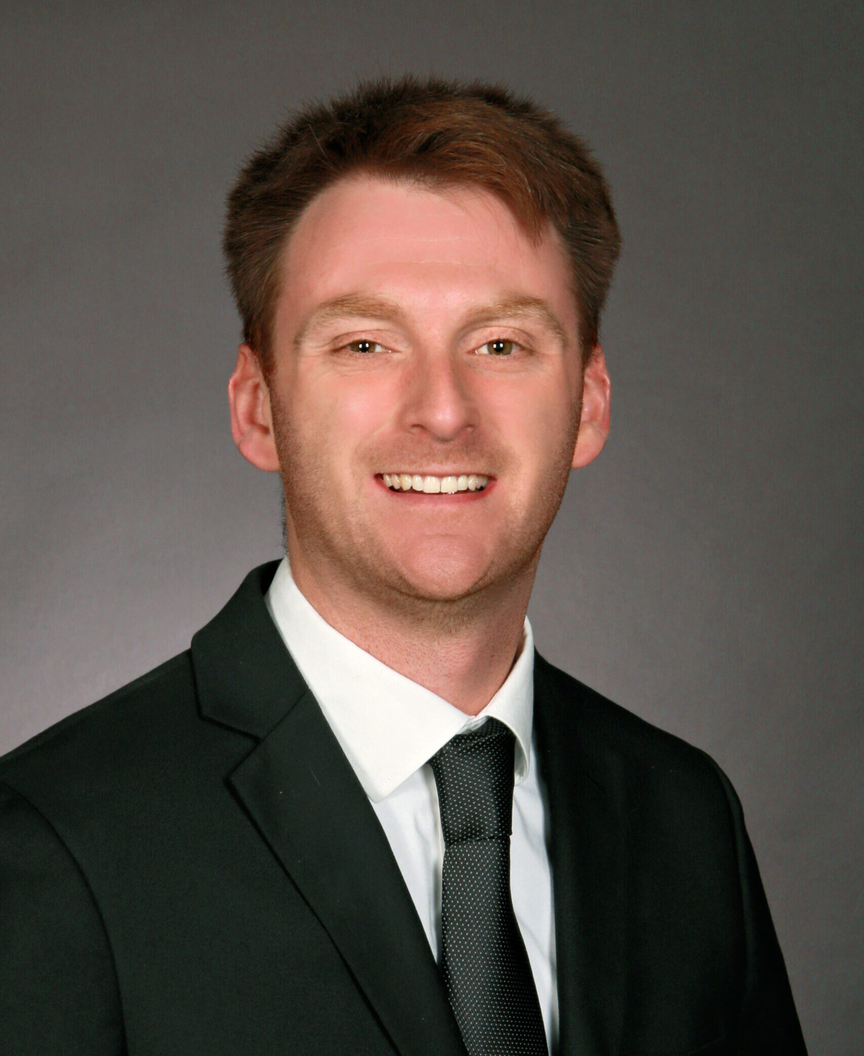 Color professional portrait of Emmitt Edwards wearing a jacket and tie