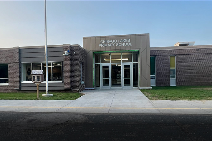 Sidewalk, flag pole and main entrance to Chisago Lakes Primary School.